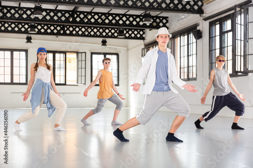 Emotional teenage dancers having hip-hop dance training at dance hall