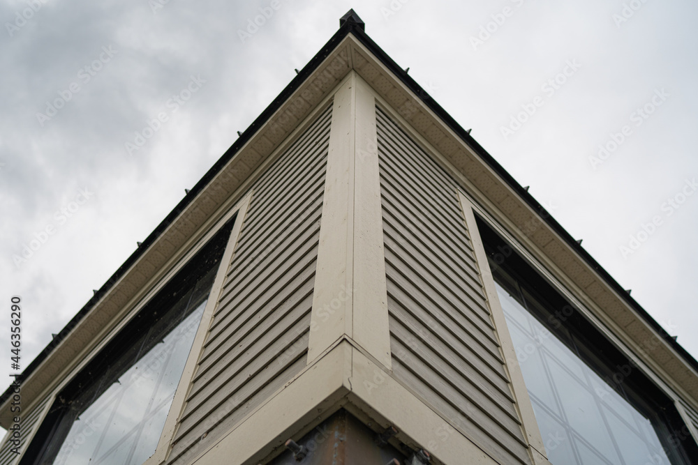 Corner building with windows in cloudy day Corner building with windows in cloudy day