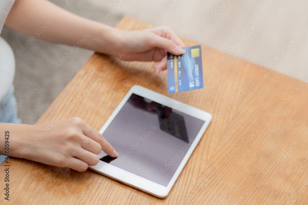 Closeup hand of young asian woman holding credit card shopping online with tablet computer blank display screen buying and payment, girl using debit card purchase or transaction, e-commerce concept. Closeup hand of young asian woman holding credit card shopping online with tablet computer blank display screen buying and payment, girl using debit card purchase or transaction, e-commerce concept.