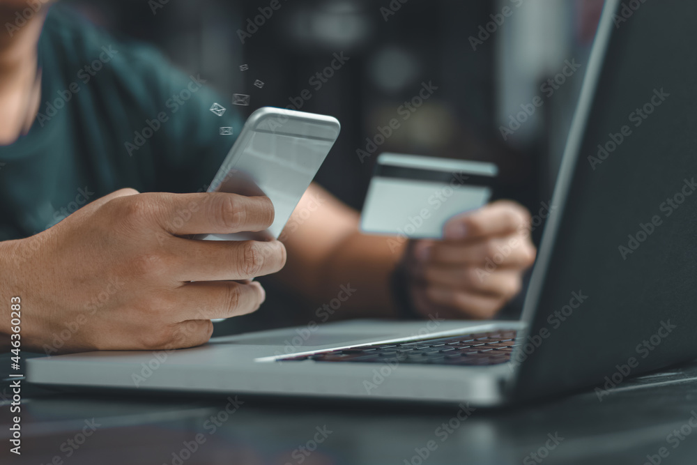 Online payment,Man's hands holding a credit card and using smart phone for online shopping,Credit card online technology shopping concept. Online payment,Man's hands holding a credit card and using smart phone for online shopping,Credit card online technology shopping concept.