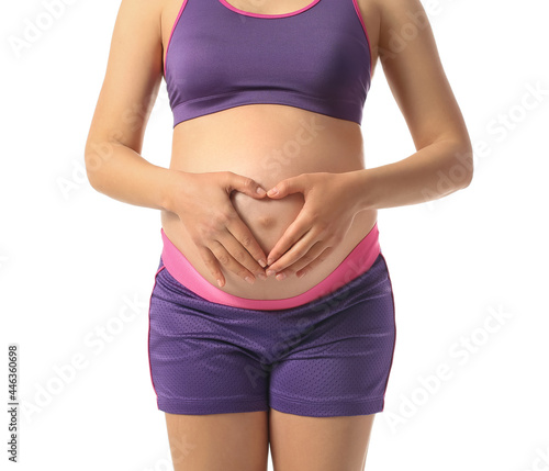 Young pregnant woman on whi...