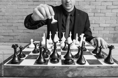 Man playing chess at table,...