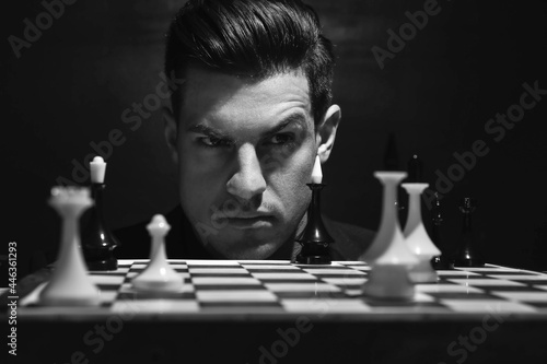 Man playing chess at table ...