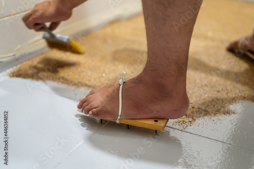 Painters' wooden shoes with nails for self leveling epoxy on floor background. Close up.