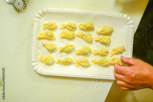 Obraz na plátně person making tortelli con la coda in the kitchen
