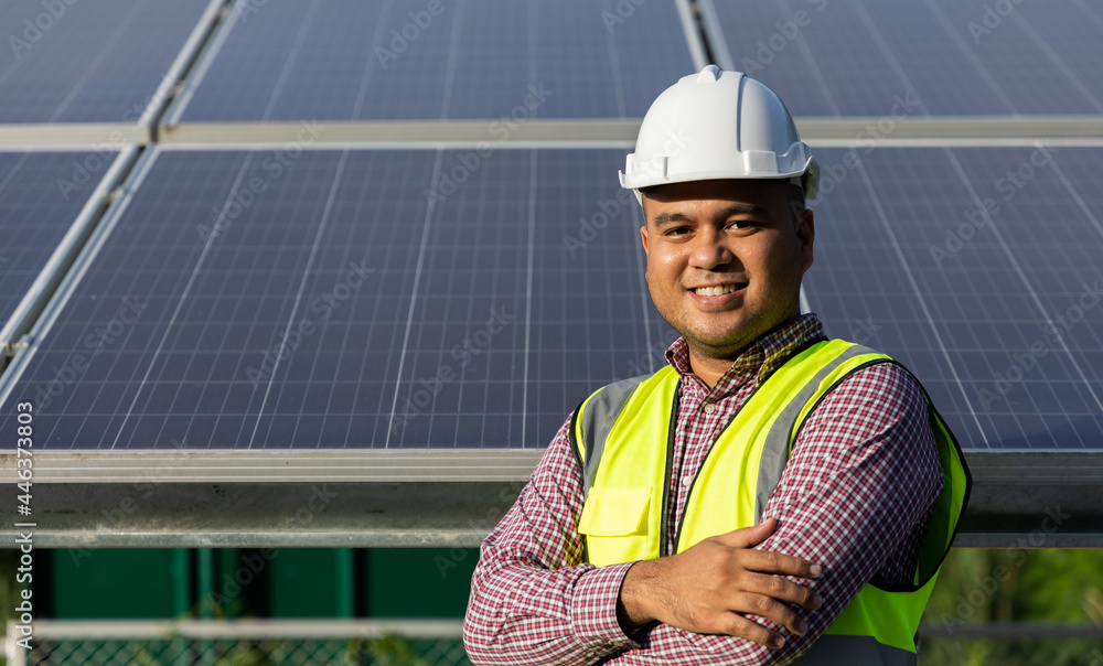 Young asian electrical engineer standing in front of Solar cell panels farm. He checking and installing. Solar generator power concept. Young asian electrical engineer standing in front of Solar cell panels farm. He checking and installing. Solar generator power concept.