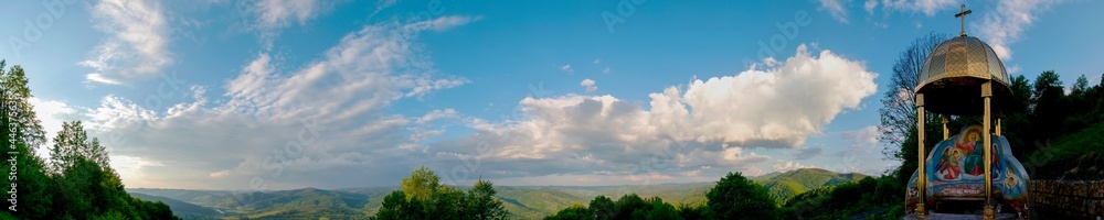 Panorama with a chapel on top of the mountain. Beautiful valley in the distance with white fog. Panorama with a chapel on top of the mountain. Beautiful valley in the distance with white fog.