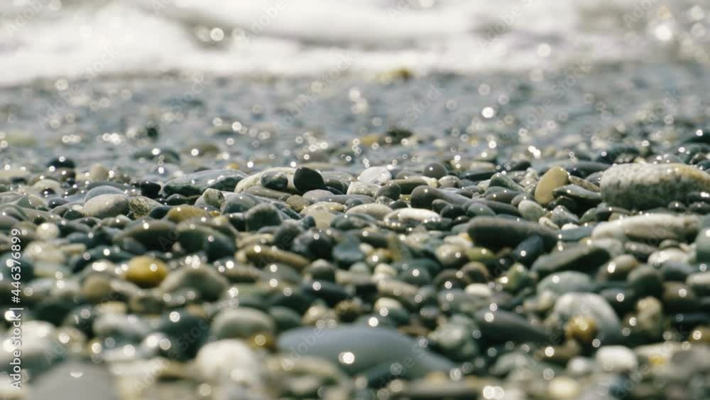 Background with small shiny sea stones washed by sea water. Background with small shiny sea stones washed by sea water.