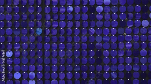 Pieces of blue metal on wall simmer and create patterns