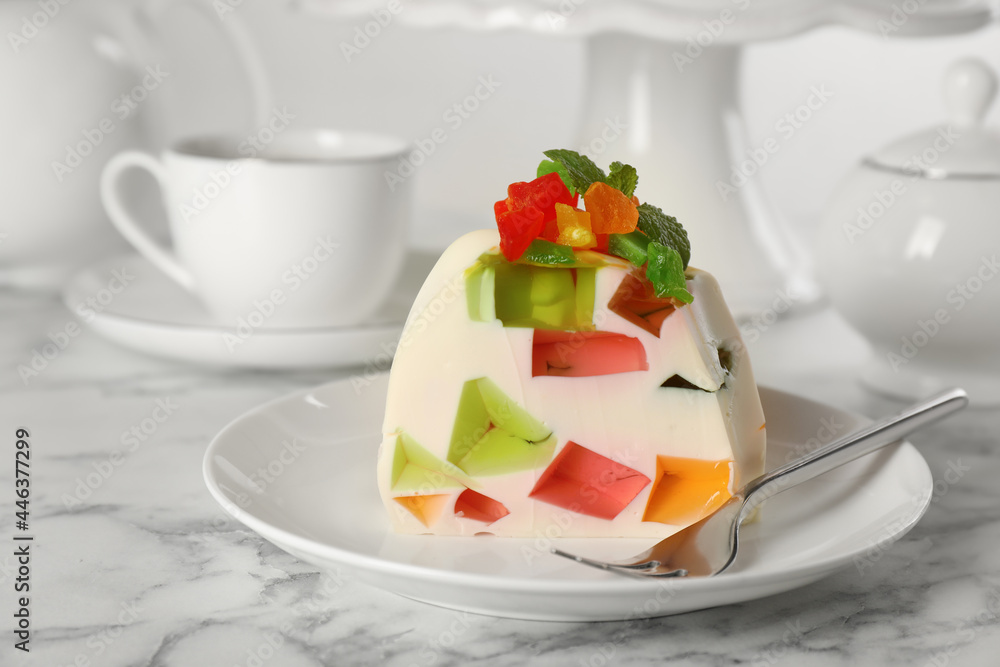 Delicious broken glass jelly dessert on white marble table Delicious broken glass jelly dessert on white marble table