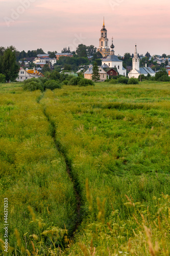 Rustic landscape with a church and a path through a field