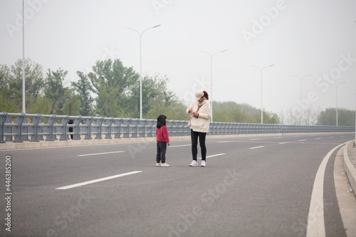 Mom and daughter standing on the road