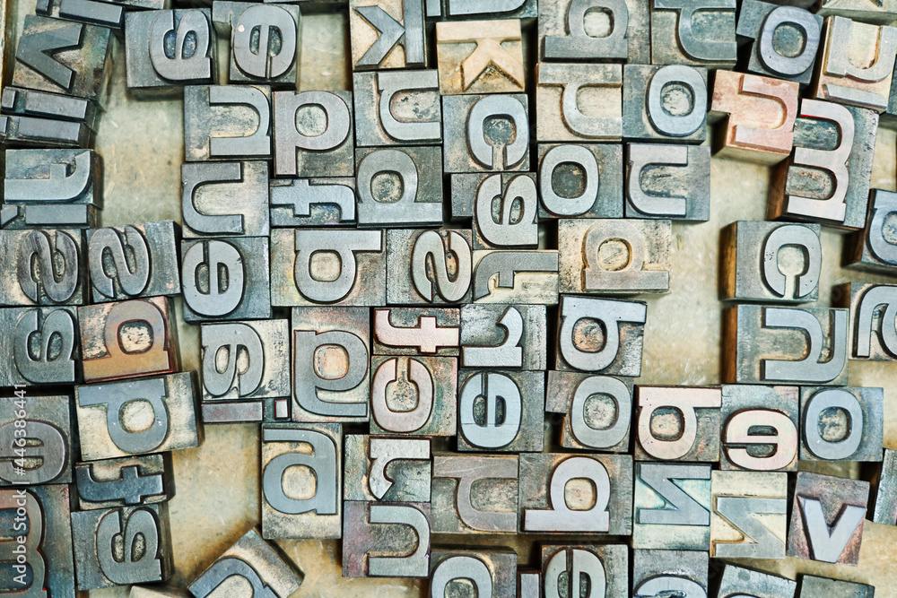 Collection of metal letters in wooden box Collection of metal letters in wooden box