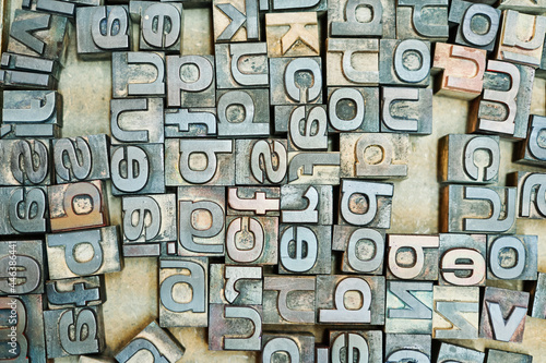 Collection of metal letters in wooden box photo