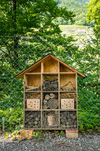 Wooden insect house in the garden. Bug hotel in natural environment. Insect hotel in Switzerland.