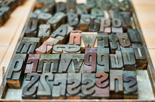Collection of metal letters and numbers in wooden box