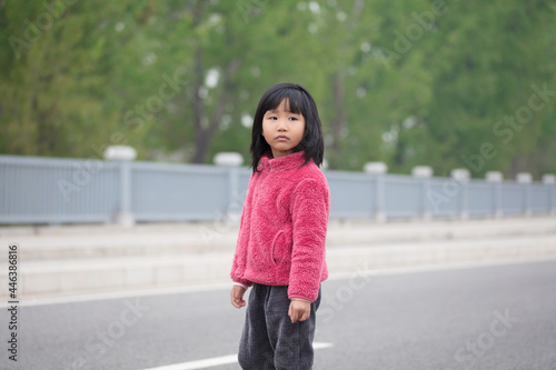 A five-year-old Chinese girl turns her head and looks into the distance