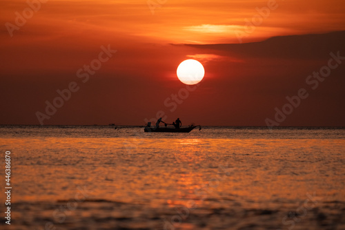 beautiful orange sunset with fisherman 