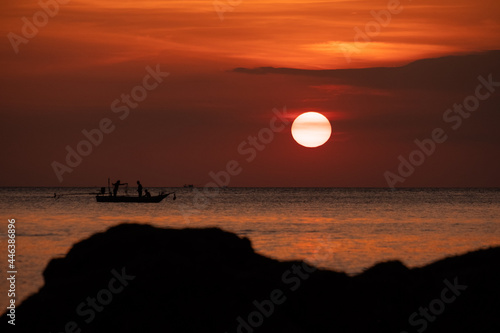 beautiful orange sunset with fishermann 