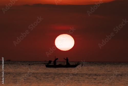 beautiful orange sunset with fisherman 