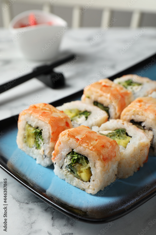 Delicious sushi rolls served on white marble table Delicious sushi rolls served on white marble table