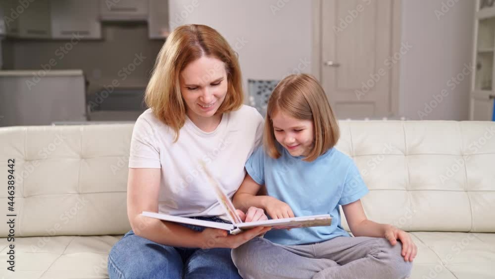 mother and daughter watch photobook family photo shoot in spring garden mother and daughter watch photobook family photo shoot in spring garden