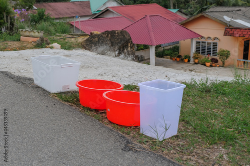 Water storage in a large plastic container because of a water supply disruption. River pollution issue.