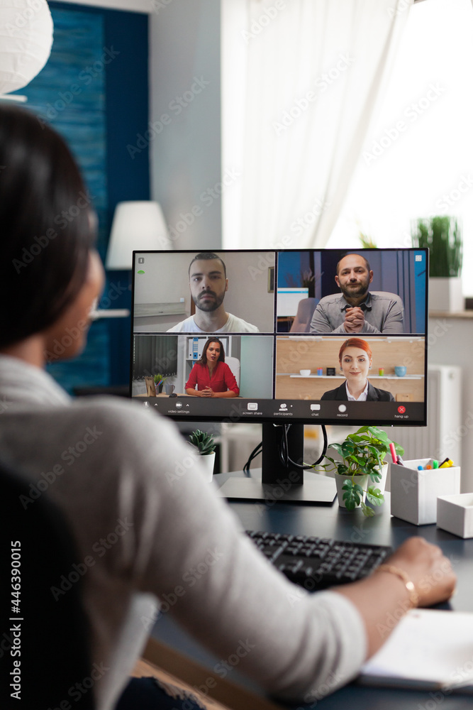 Black woman sitting at desk working remote at marketing course ideas discussing with virtual univeristy team during online videocall meeting conference, Student using high school elearning platform Black woman sitting at desk working remote at marketing course ideas discussing with virtual univeristy team during online videocall meeting conference, Student using high school elearning platform