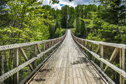 View from the Rimouski river on the highest suspended footbridge in Quebec, 63 meters high and 99 meters long, located in Canyon des Portes de l'Enfer (Hell's gate Canyon) in Quebec, Canada