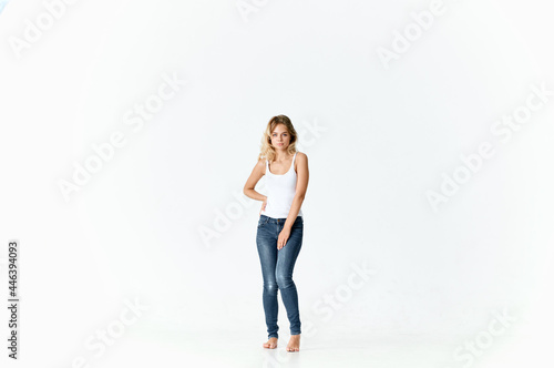 cheerful woman woman in jeans barefoot dancing on the floor