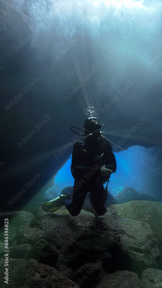 Fototapeta premium Scuba diver in glacier cave