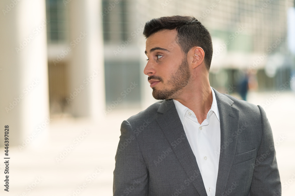 Portrait of a young handsome man looking at his side Portrait of a young handsome man looking at his side