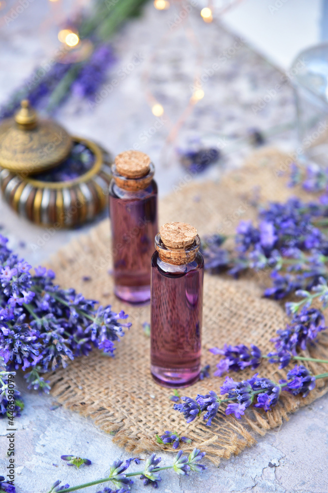 Lavender oil and lavender flowers on bokeh background. Lavender oil and lavender flowers on bokeh background.