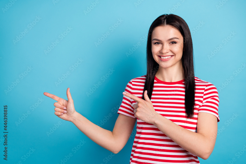 Fototapeta premium Photo of happy cheerful beautiful smiling young girl point fingers copyspace advertisement isolated on blue color background