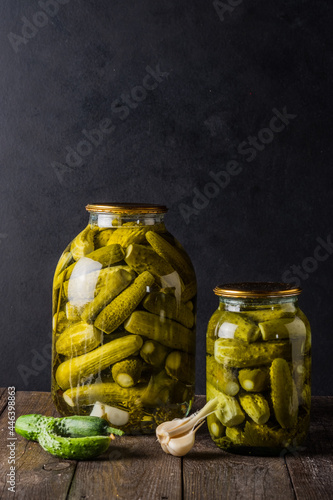 Pickled cucumbers in the jar. Ingredients for pickling cucumbers. Cucumbers, dill, garlic. Glass jars with pickles