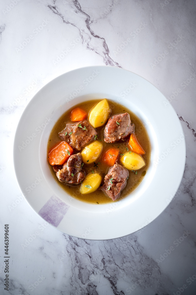 Tasty stew with vegetables and meat in plate on table Tasty stew with vegetables and meat in plate on table