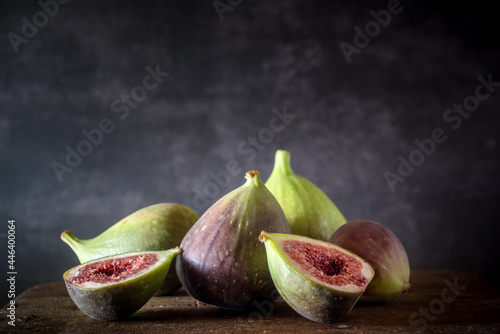 Ripe figs placed on wooden table photo