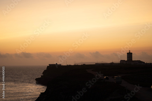 Lighthouse on the coastline at sunset  summer day