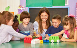 Children and educator play with building blocks