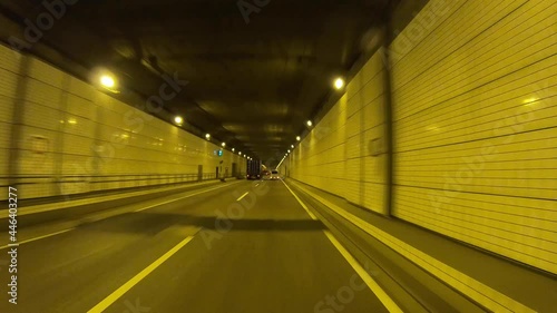 A pov of driving cityscape on the urban street through the tunnel in Tokyo photo