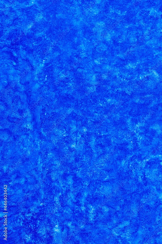 Blue abstract textured background surface with grungy paint style effect.  Decorative backdrop with space for text for artistic projects, decoration, cover, etc.