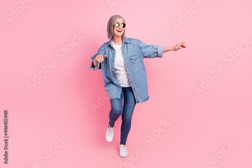 Full length photo of cheerful positive old woman dance good mood free time isolated on pink color background