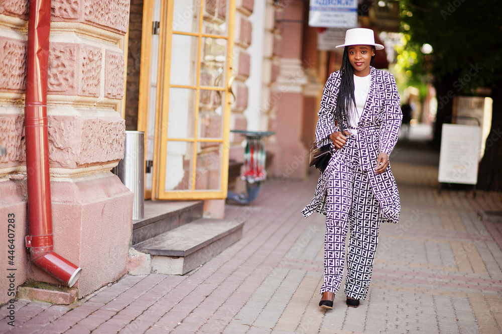Beautiful african american woman natural makeup wear fashion clothes casual black and white dress code office style total blouse and pants suit and hat.