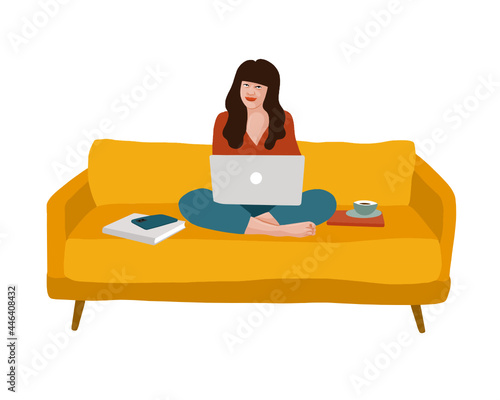 Person on a couch with a computer on their lap and books around them.