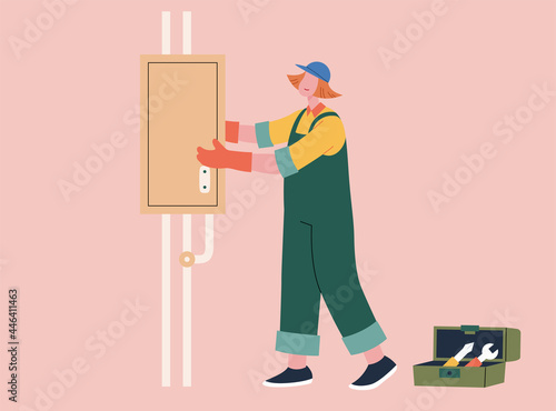 Female electrician fixing fuse box