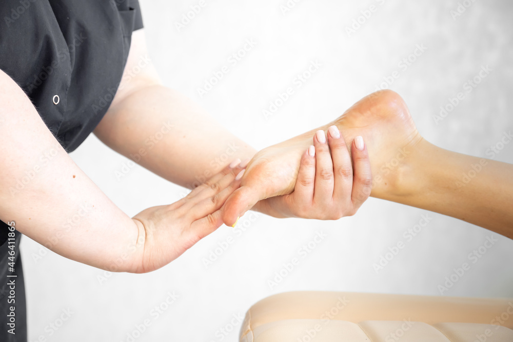 Fototapeta premium A masseur girl does a foot massage. Relax