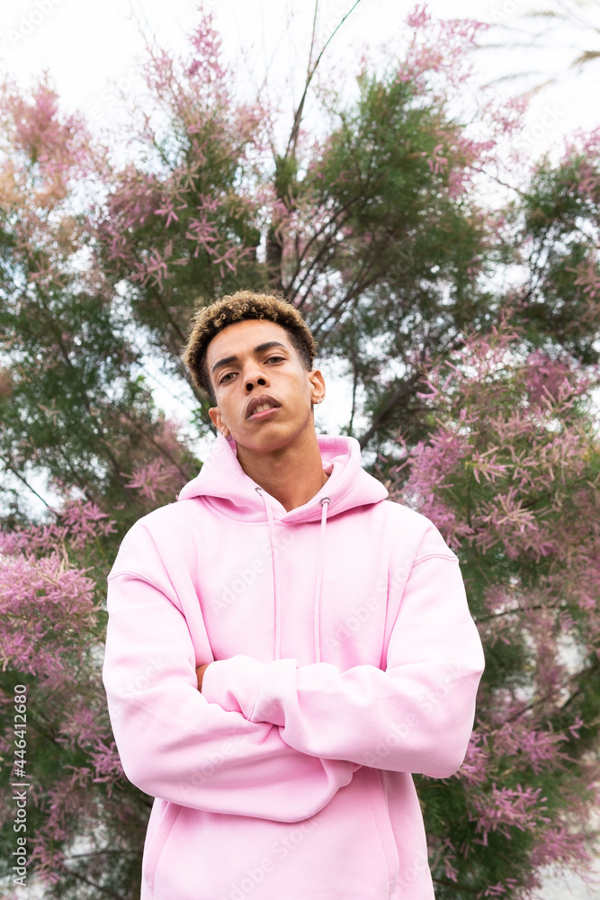 Informal young ethnic guy in pink hoodie Informal young ethnic guy in pink hoodie
