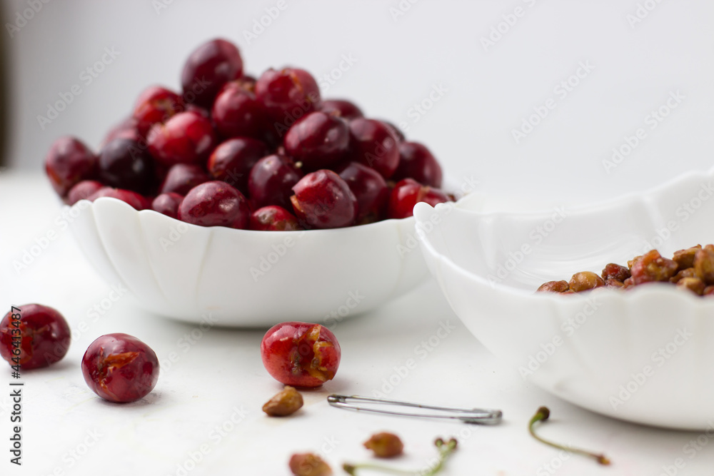 Cherry without pit on a white background. The process of removing bones from cherries Cherry without pit on a white background. The process of removing bones from cherries