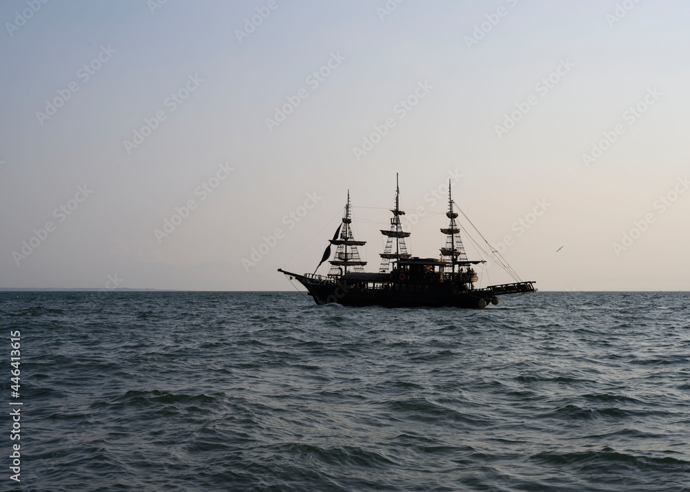 Silhouette of a ship with masts at sunset Silhouette of a ship with masts at sunset