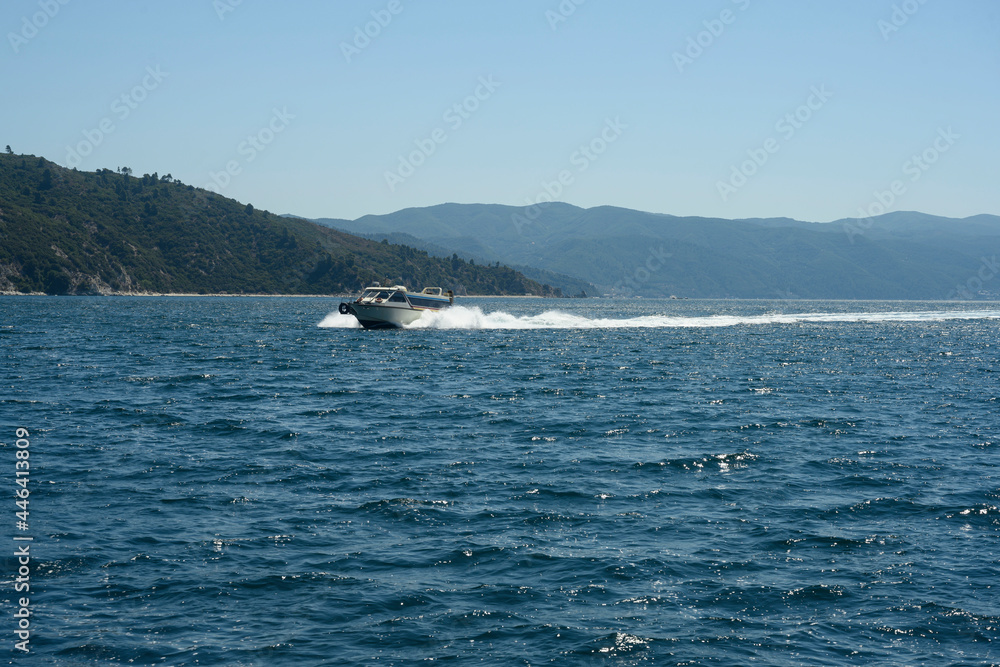 Speedboat cruising along Mount Athos Speedboat cruising along Mount Athos